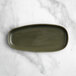 An Acopa Highlands juniper green rectangular china tray on a marble counter.