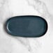 An Acopa Highlands skyfall blue rectangular coupe china tray on a marble surface.