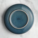 An Acopa Highlands skyfall blue coupe china plate with a white rim.