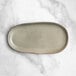 An Acopa Highlands heather gray rectangular china tray on a marble surface.