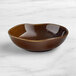 An Acopa Highlands hazel china bowl with a curved edge on a marble surface.