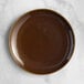 An Acopa Highlands brown china plate on a marble surface.