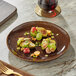 An Acopa Highlands china plate with food on a table.