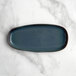 An Acopa Highlands skyfall blue rectangular coupe tray on a marble surface.