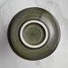 An Acopa Highlands juniper green sauce cup with a white rim.