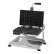 A Krampouz Brussels style waffle maker with many square waffles on the tray.