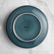 An Acopa Highlands blue china plate with a white rim.