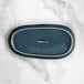 An oval blue Acopa Highlands china tray with a white rim.
