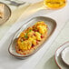 A rectangular heather gray Acopa Highlands china tray with cauliflower and sauce on it.