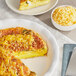 A plate of quiche with shredded Tillamook medium yellow cheddar cheese on top.