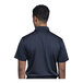 A man wearing a navy blue Uncommon Chef polo shirt.
