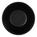 A close up of a black Cal-Mil melamine ramekin with a white circle in the middle.