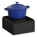 A blue pot on a black square induction burner.