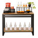 A Cal-Mil Madera rustic pine nesting merchandising table with a variety of bottles and a plant.