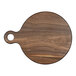 A round walnut serving board with a handle.