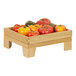 A Cal-Mil oak display stand with a wooden tray of tomatoes on it.