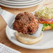 A plate with a Ratner's Veggie Grillers vegan burger on it with a fork.