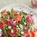 A plate of food with blood orange and cheese on a table.