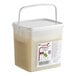 A plastic bucket with a white lid and a white handle containing Les Vergers Boiron Lime 100% Fruit Puree.