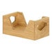 An oak Cal-Mil napkin holder with a handle on each side and a hole pattern on the front.