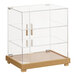 A Cal-Mil clear glass bakery display case with a faux wood base.