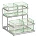 A metal rack holding two glass containers on a metal stand.