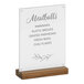 A Cal-Mil walnut base card holder with a white sign displaying black text.