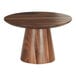 A round wooden table with a walnut cake stand on top.