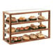 A Cal-Mil walnut bakery display case with breads and pastries on a table.