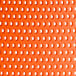 A close up of the perforated orange resin surface of a Lancaster Table & Seating Rio Sunset Orange side chair.