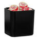 A black Cal-Mil crock with round containers inside.