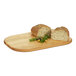 A loaf of bread with olives on a Cal-Mil oak serving board.