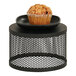 A muffin on a black metal display stand.