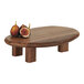 A Cal-Mil walnut organic display stand with figs on it.