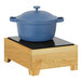 A blue pot on a wooden stand with a wood block top.