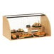 A Cal-Mil faux wood arched bakery display case filled with pastries.