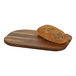 A loaf of bread on a walnut wooden serving board.