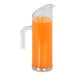 A Cal-Mil ribbed polycarbonate pitcher with orange liquid inside.