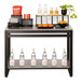 A Cal-Mil Ashwood nesting merchandising table with a shelf of bottled beverages and a plant.