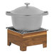 A grey pot with a lid on a wooden stand.