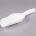 A white plastic Fineline ice scoop with a handle.