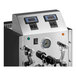 An automatic black two-wand milk and beverage steamer with a stainless steel front panel, control switches, and pressure gauge.