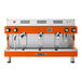 An orange and silver Astra Mega III automatic espresso machine with three spouts.
