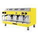 A yellow and silver Astra Mega III automatic espresso machine.