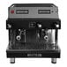 An Astra Mega II black and silver automatic espresso machine with two cups on top.