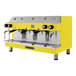 A yellow and silver Astra Mega III semi-automatic espresso machine.