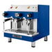 A blue and silver Astra Mega II compact espresso machine with two cups on top.