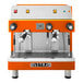 An orange and silver Astra Mega II compact espresso machine with two spouts.