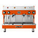 An orange and silver Astra Mega II espresso machine with two spouts.