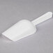 A white Fineline plastic utility and ice scoop.